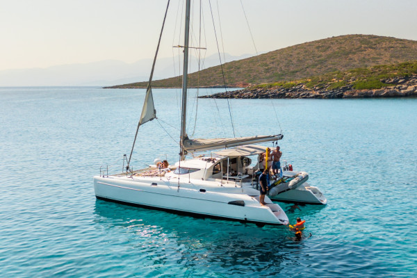 Sailing Cruise vs Private Cruises in Crete: Which Is right for you?. The image shows a private boat sailing to Spinalonga.