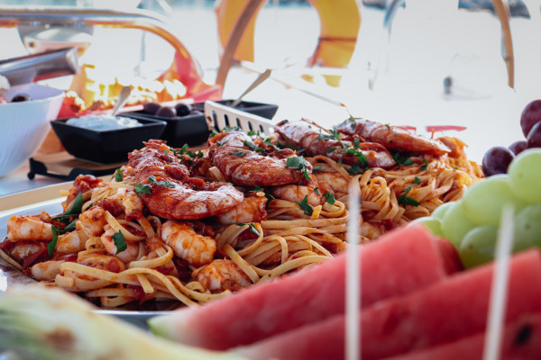 Sunset Sailing Cruises in Crete: The top romantic sea experience . The image shows food on board. 