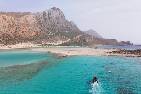 Sunset Sailing Cruises in Crete: The top romantic sea experience . The image shows a boat sailing to Gramvousa. 